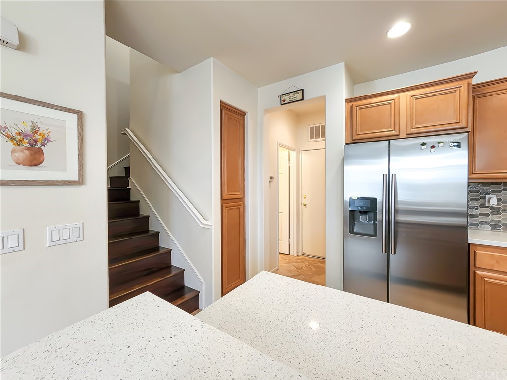 8024 Tulsa Place, Unit 107 Rancho Cucamonga, CA 91730 - Photo 9 of 35 a kitchen with stainless steel appliances a refrigerator and a stove top oven