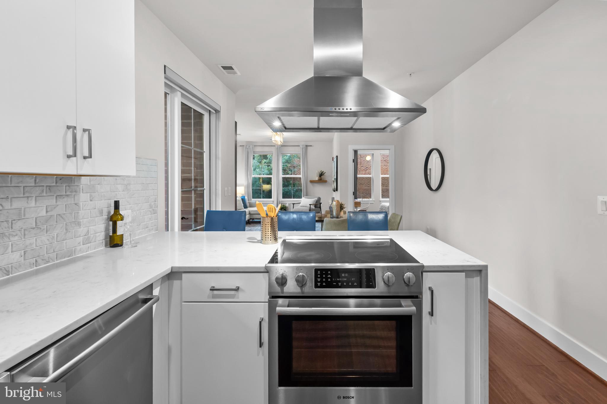 1411 Key Boulevard, Unit 304 Arlington, VA 22209 - Photo 11 of 57 a kitchen with a stove and a chandelier