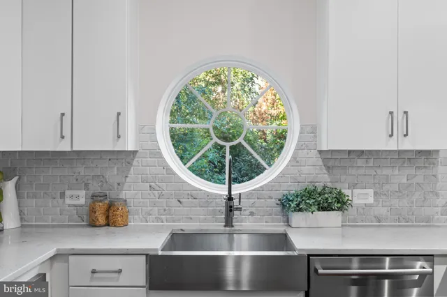 a kitchen with a stove and a chandelier