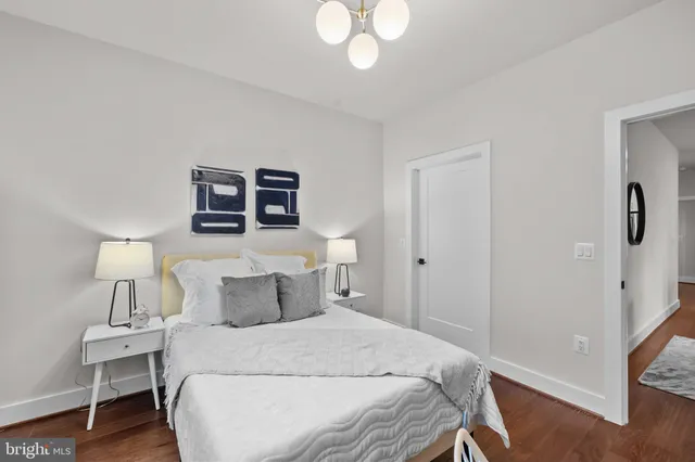 a bedroom with a bed and a chandelier