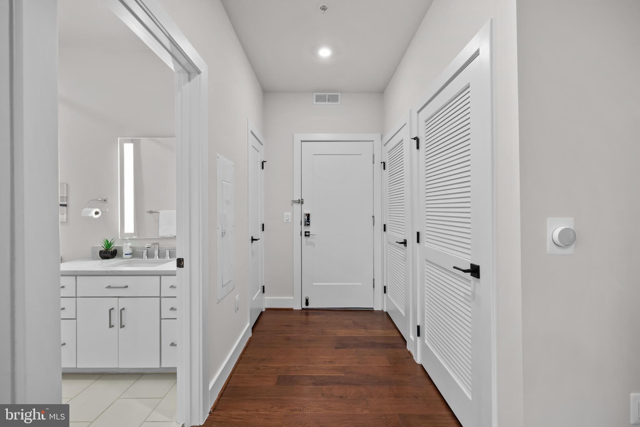 1411 Key Boulevard, Unit 304 Arlington, VA 22209 - Photo 21 of 57 a view of a hallway with granite countertop wooden floor