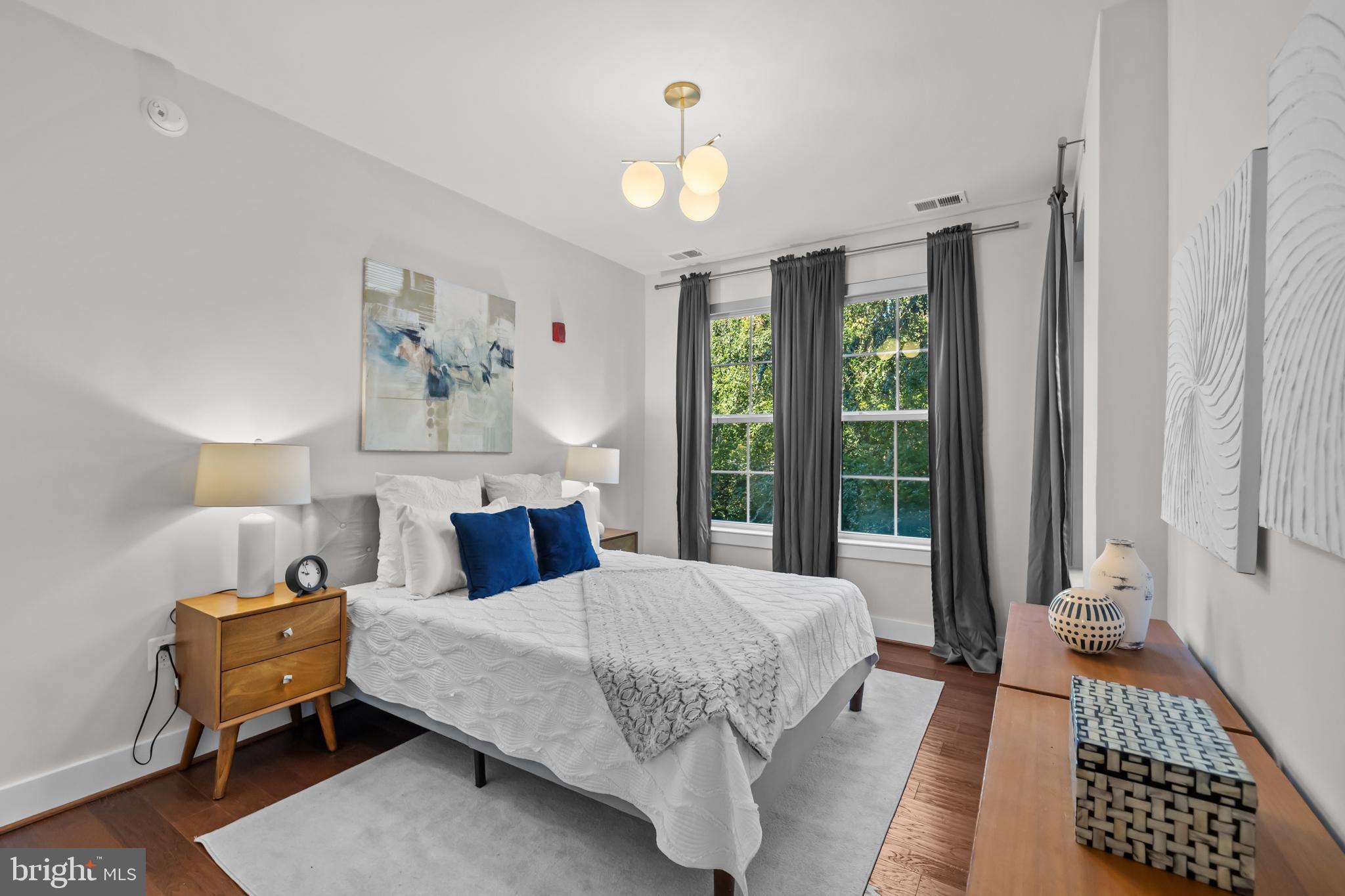 1411 Key Boulevard, Unit 304 Arlington, VA 22209 - Photo 22 of 57 a bedroom with a bed and a window