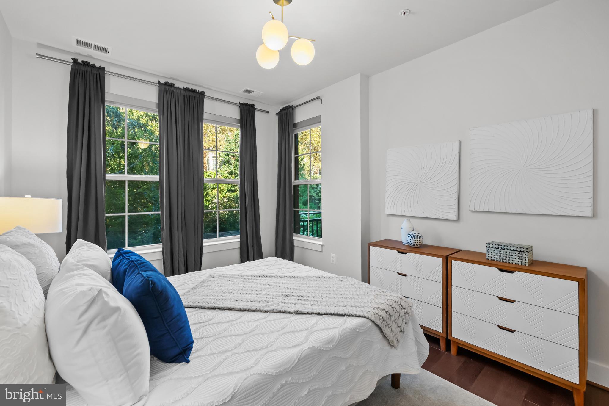 1411 Key Boulevard, Unit 304 Arlington, VA 22209 - Photo 25 of 57 a bedroom with a large bed and a large window