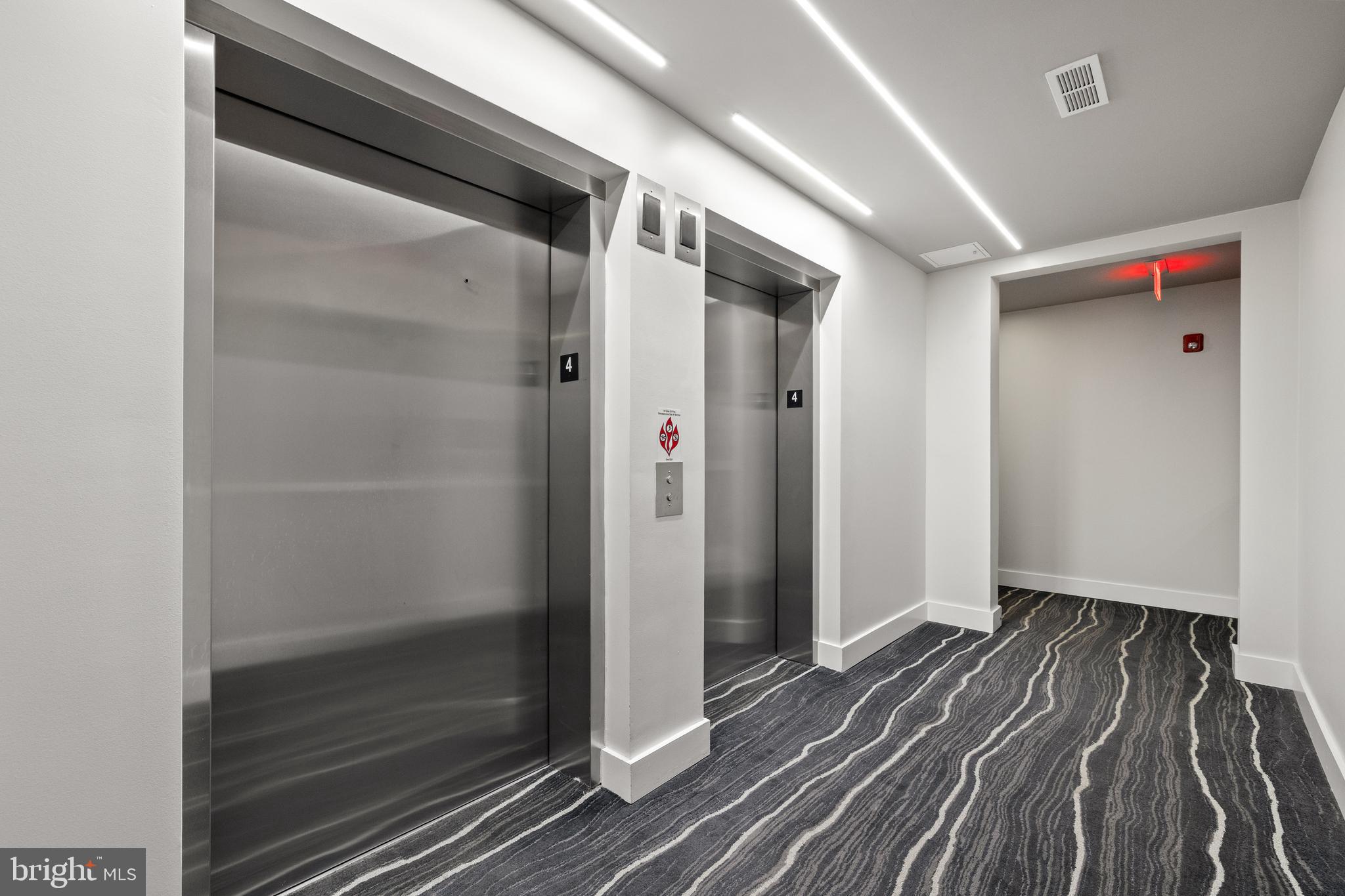 1411 Key Boulevard, Unit 304 Arlington, VA 22209 - Photo 35 of 57 a view of hallway with wooden floor