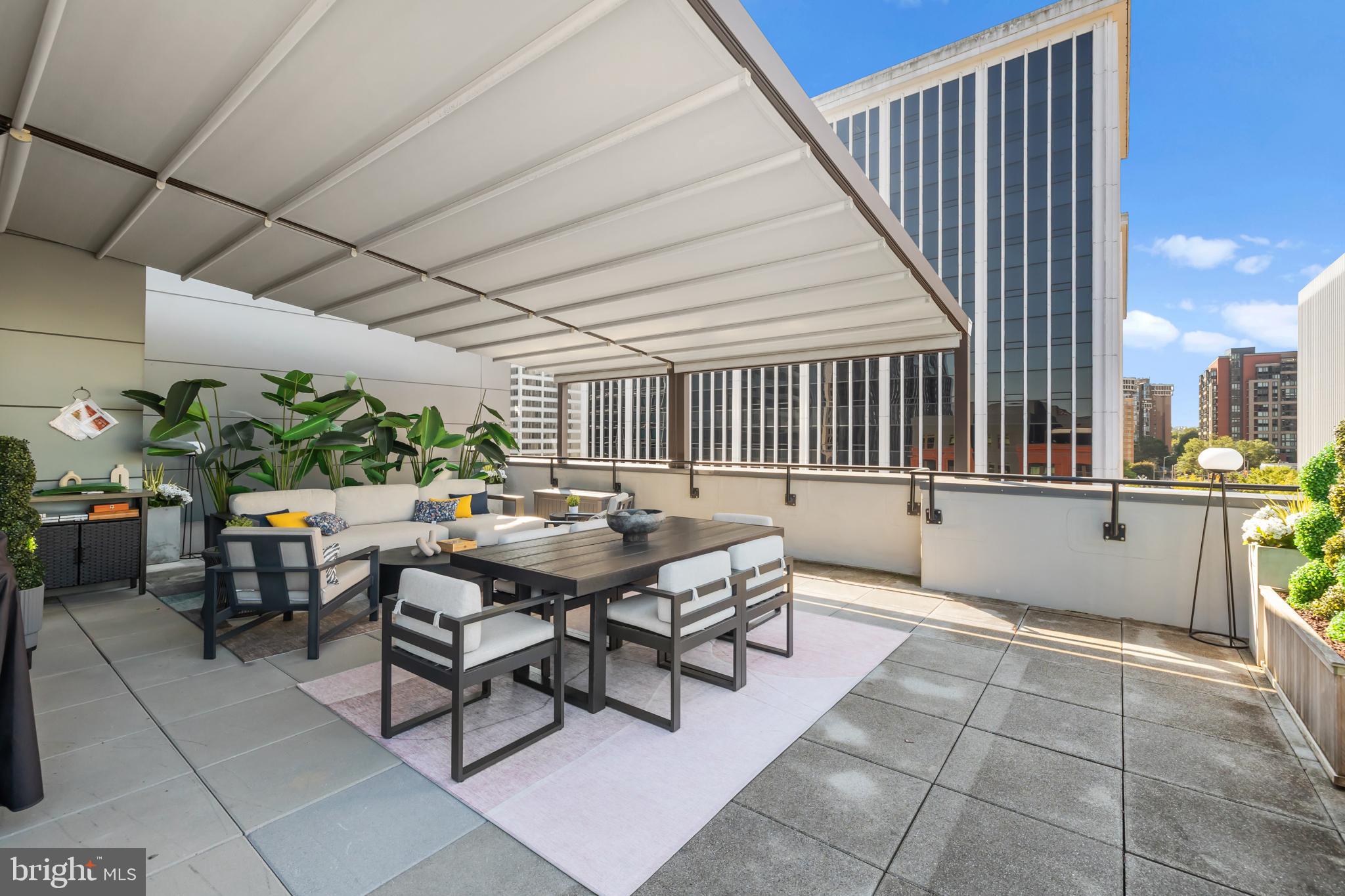 1411 Key Boulevard, Unit 304 Arlington, VA 22209 - Photo 36 of 57 a patio with table and chairs