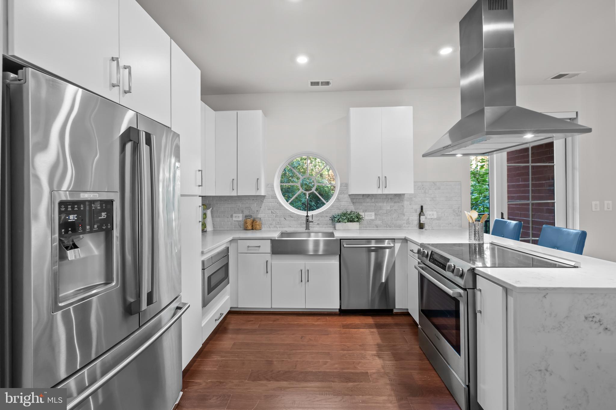 1411 Key Boulevard, Unit 304 Arlington, VA 22209 - Photo 5 of 57 a kitchen with stainless steel appliances granite countertop a sink stove and refrigerator