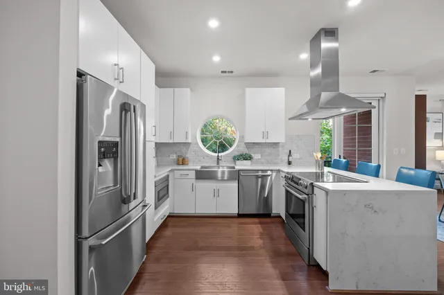 a kitchen with a refrigerator sink and stove