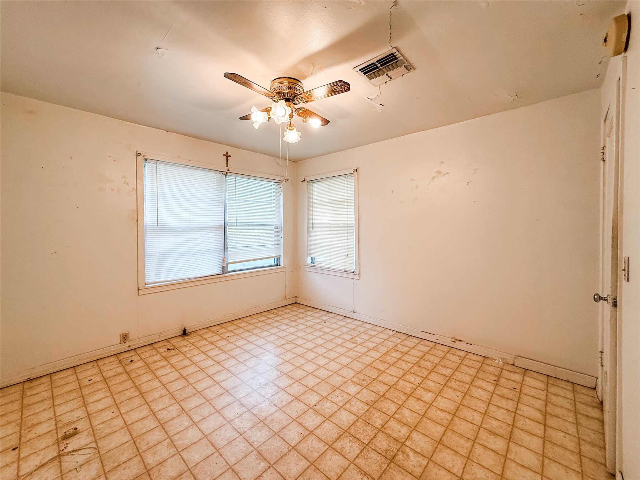 1002 Neiser Lane Weimar, TX 78962 - Photo 13 of 23 an empty room with windows and fan