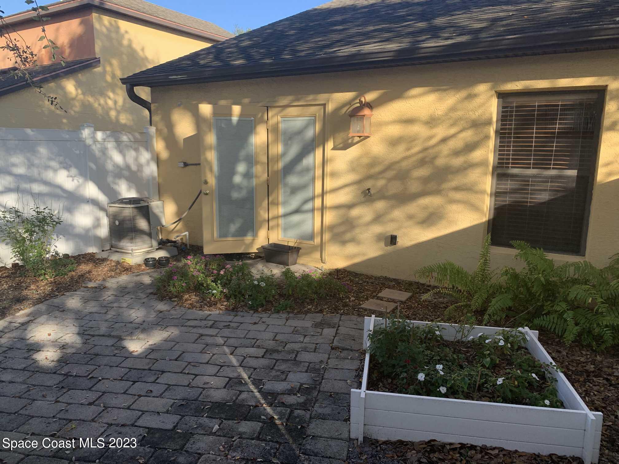 1030 Luminary Circle, Unit 106 Melbourne, FL 32901 - Photo 13 of 14 a view of backyard with wooden fence