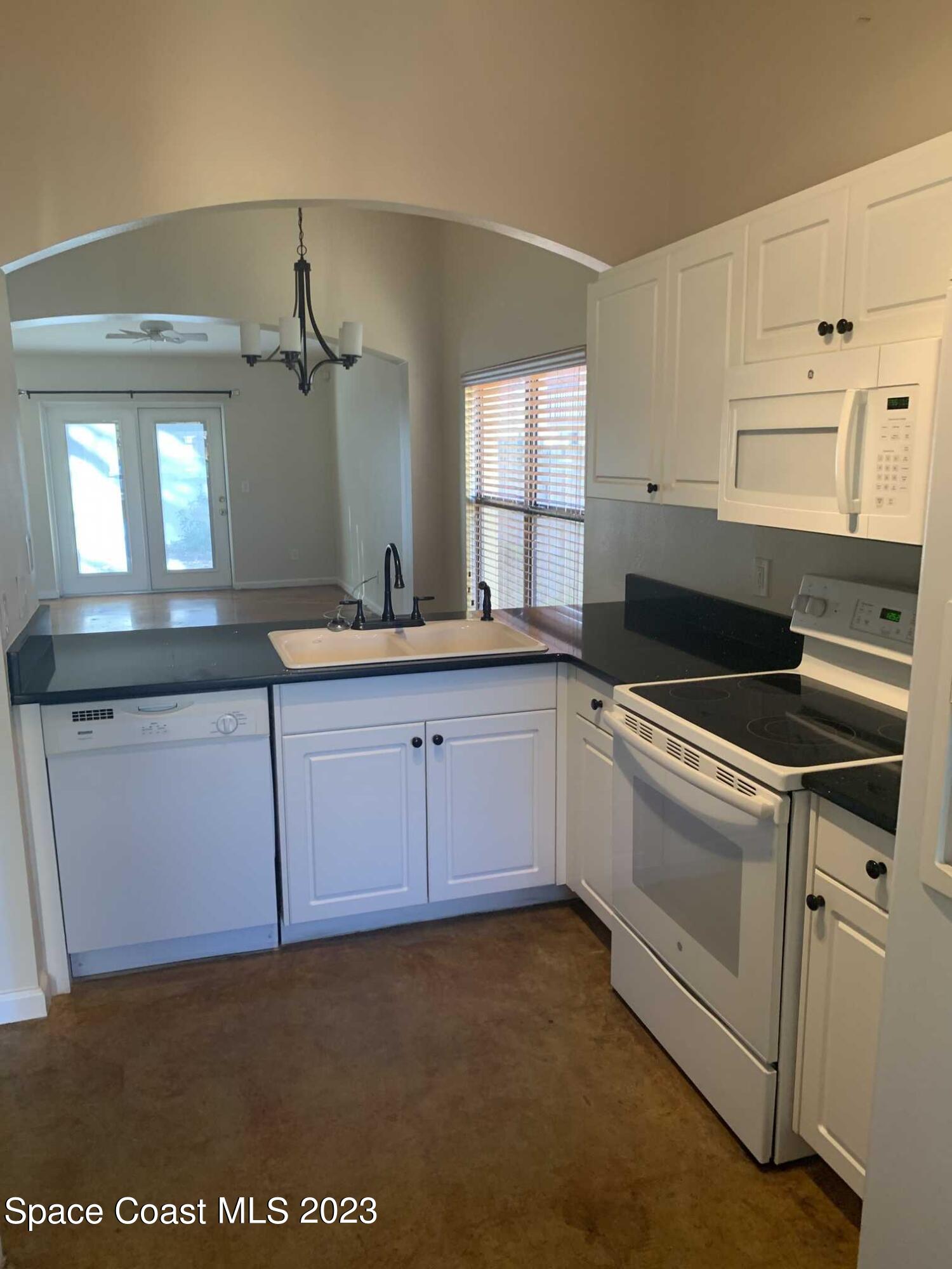 1030 Luminary Circle, Unit 106 Melbourne, FL 32901 - Photo 3 of 14 a kitchen that has a sink and a stove