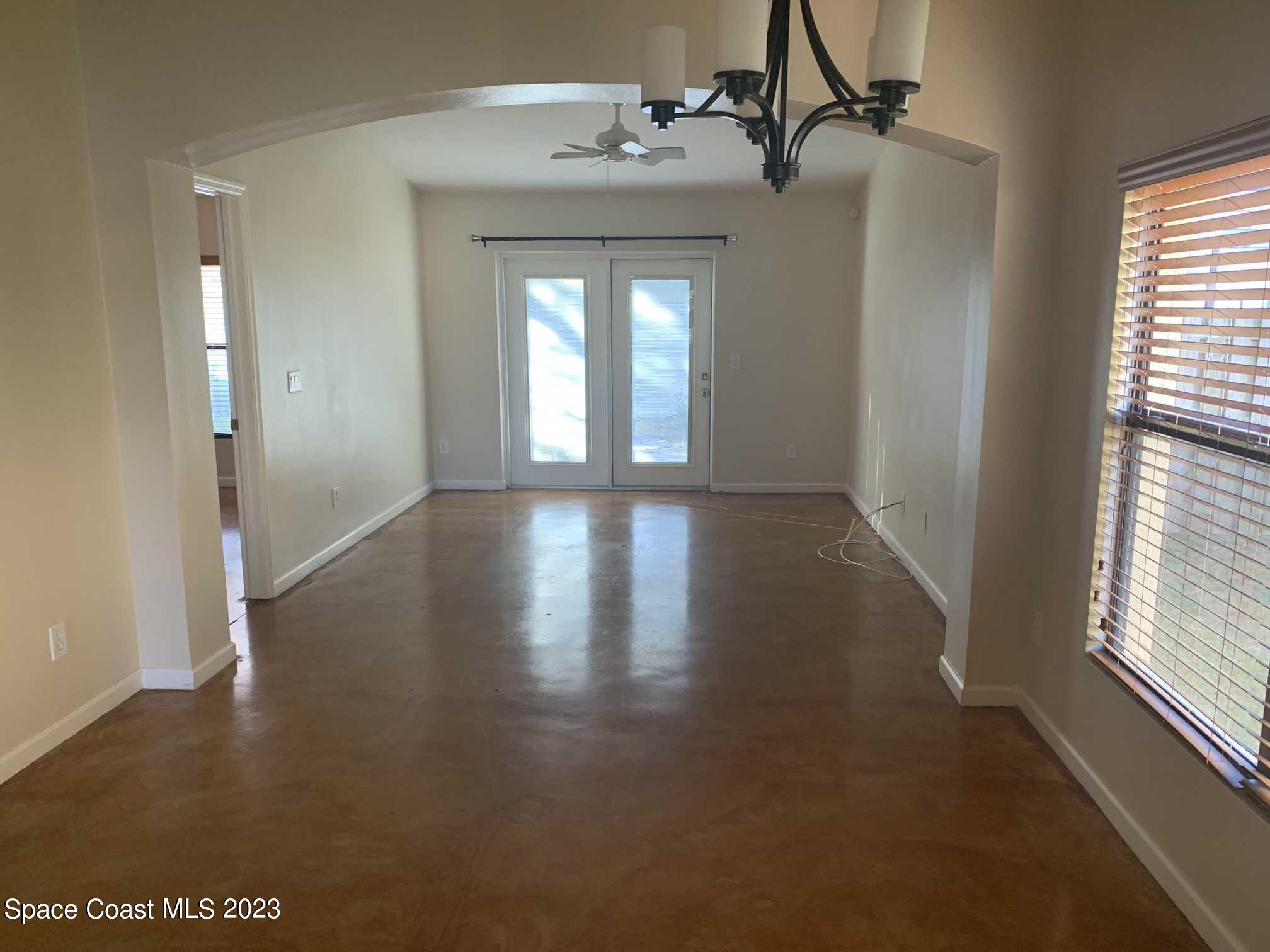 1030 Luminary Circle, Unit 106 Melbourne, FL 32901 - Photo 4 of 14 wooden floor in an empty room with a window