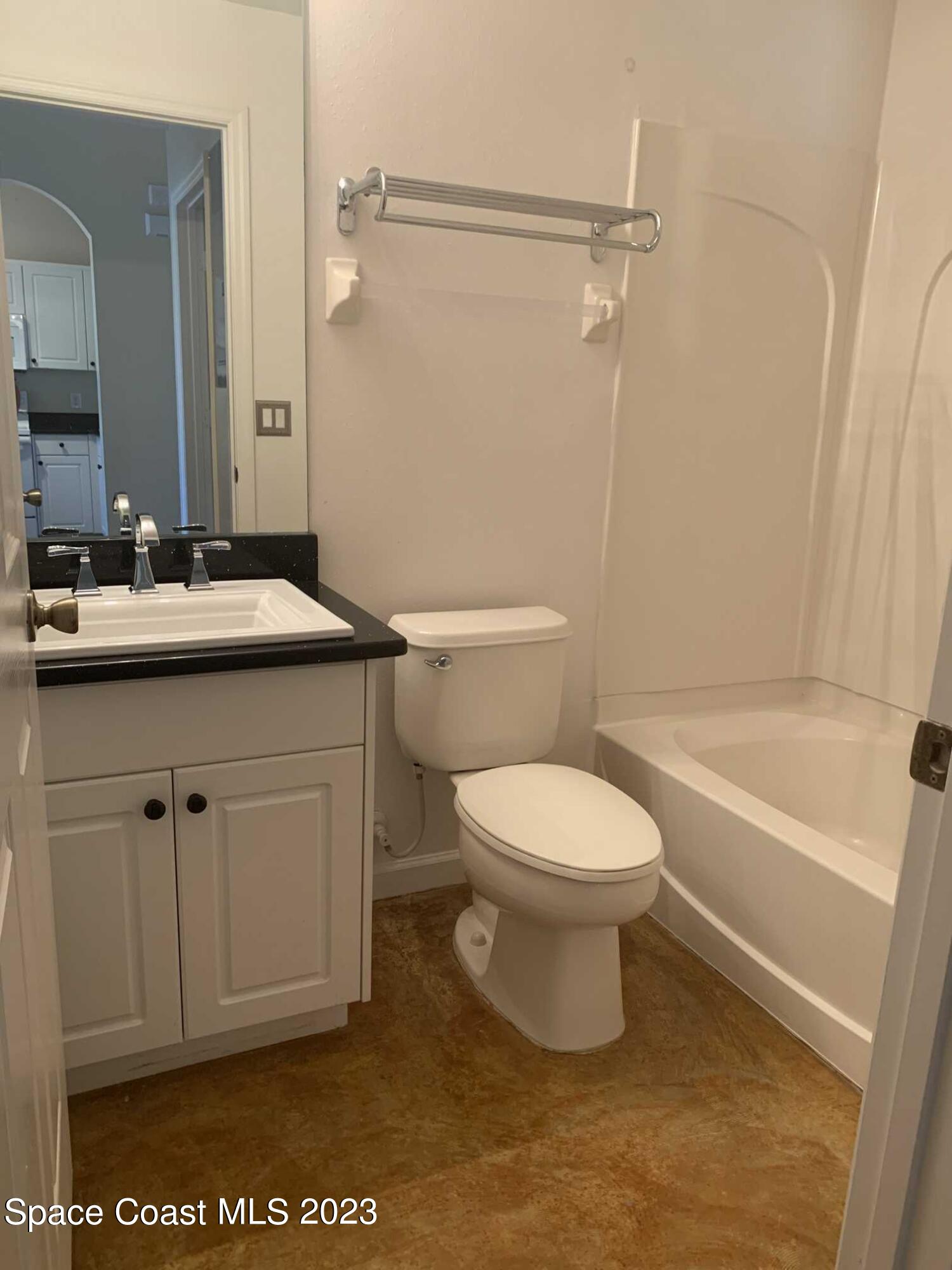 1030 Luminary Circle, Unit 106 Melbourne, FL 32901 - Photo 6 of 14 a bathroom with a sink a toilet and a bathtub