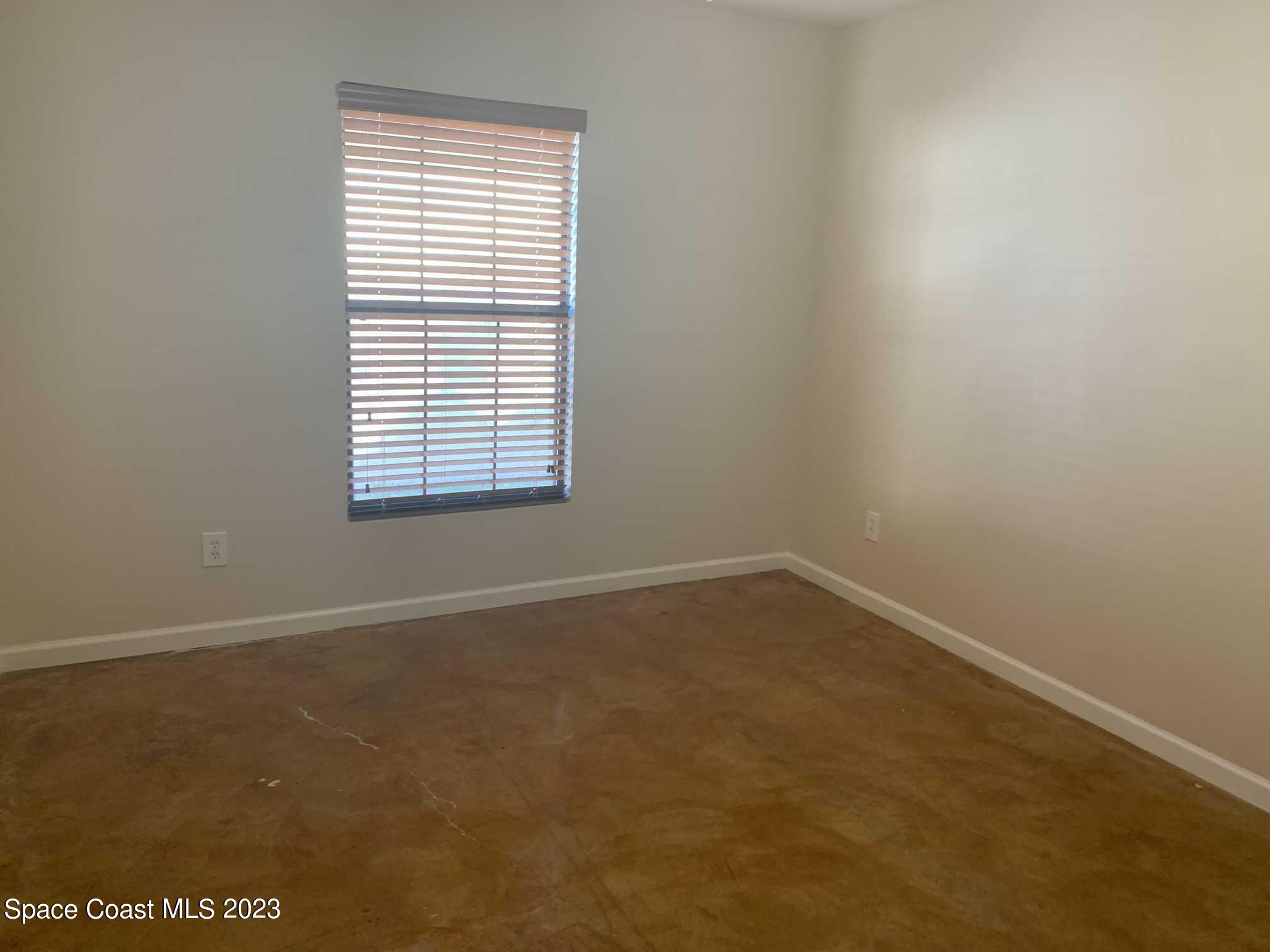 1030 Luminary Circle, Unit 106 Melbourne, FL 32901 - Photo 7 of 14 an empty room with a window