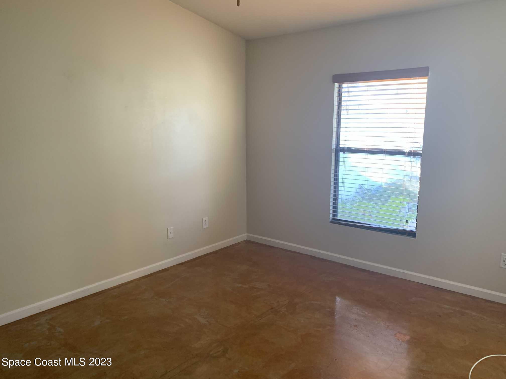 1030 Luminary Circle, Unit 106 Melbourne, FL 32901 - Photo 9 of 14 an empty room with a window
