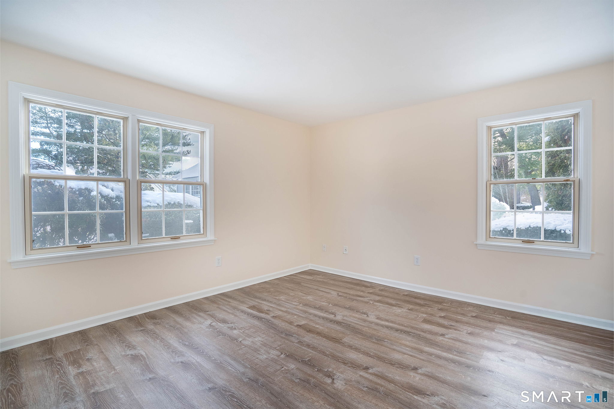 4 Currycross Road, Unit 4 Madison, CT 06443 - Photo 22 of 29 a view of an empty room with wooden floor and a window