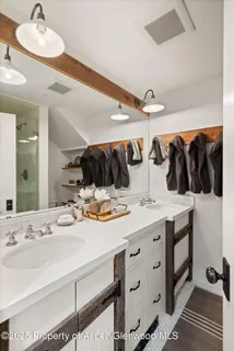 a bathroom with a double vanity sink and a mirror