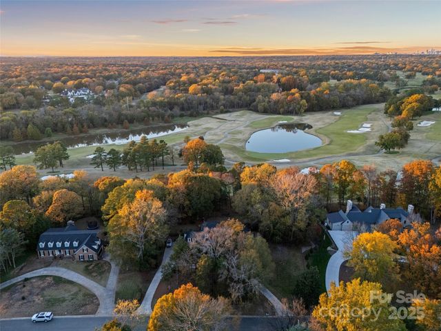 an aerial view of lake residential house with outdoor space and swimming pool
