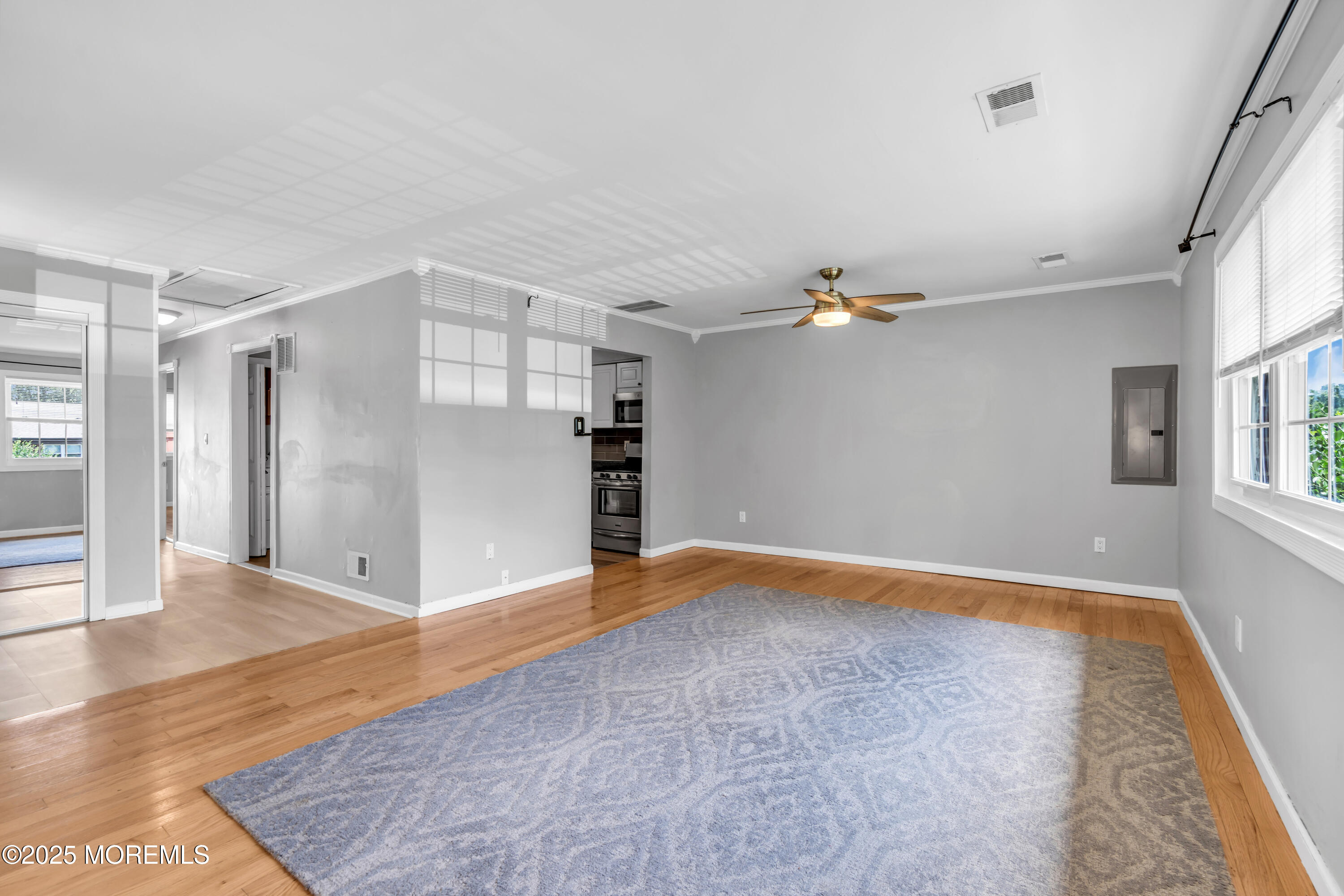 94 Greenwood Loop Road Brick, NJ 08724 - Photo 11 of 22 an empty room with wooden floor and windows