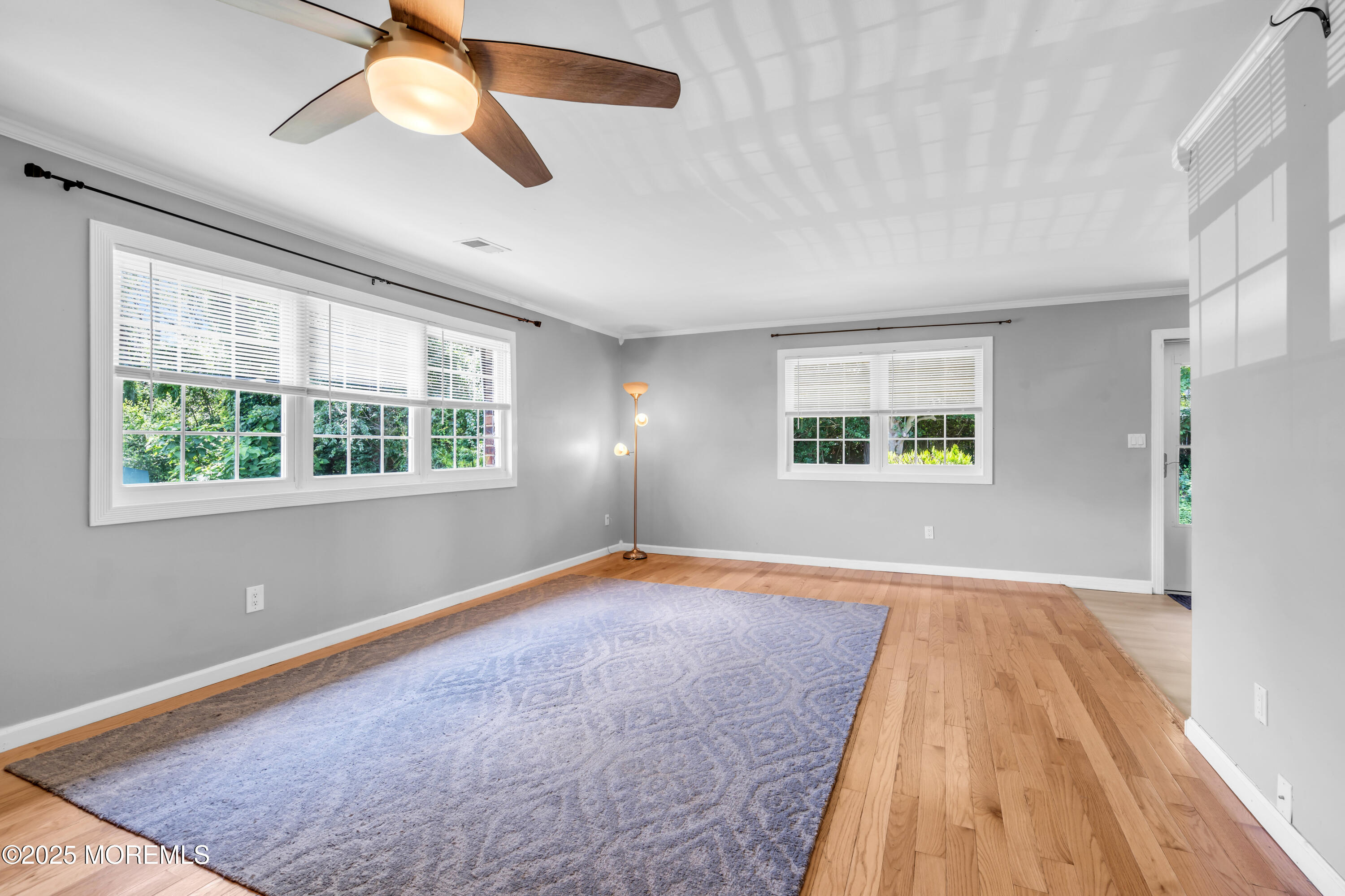 94 Greenwood Loop Road Brick, NJ 08724 - Photo 12 of 22 a view of an empty room with a window and wooden floor