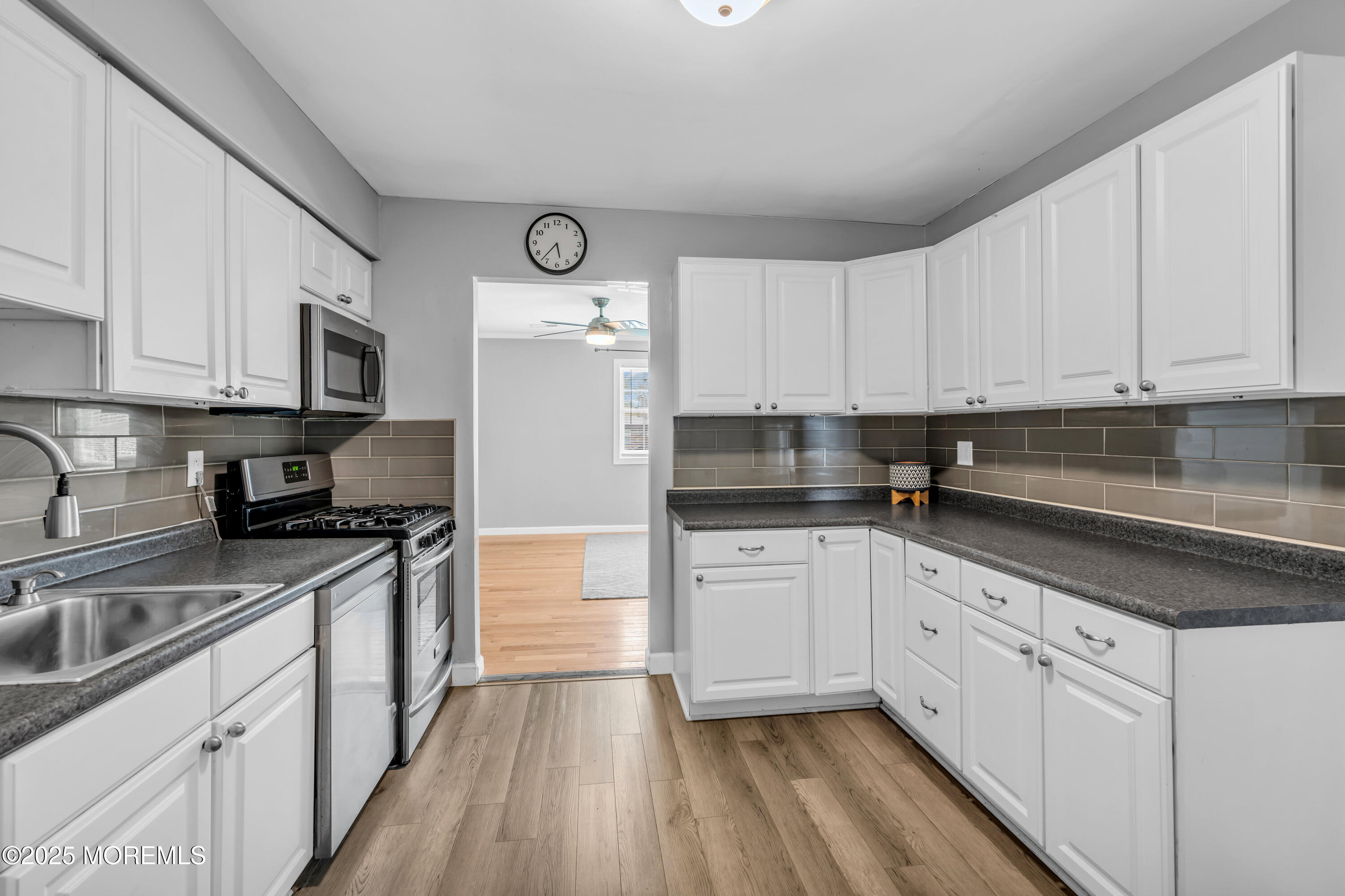 94 Greenwood Loop Road Brick, NJ 08724 - Photo 15 of 22 a kitchen with stainless steel appliances granite countertop a stove a sink and white cabinets