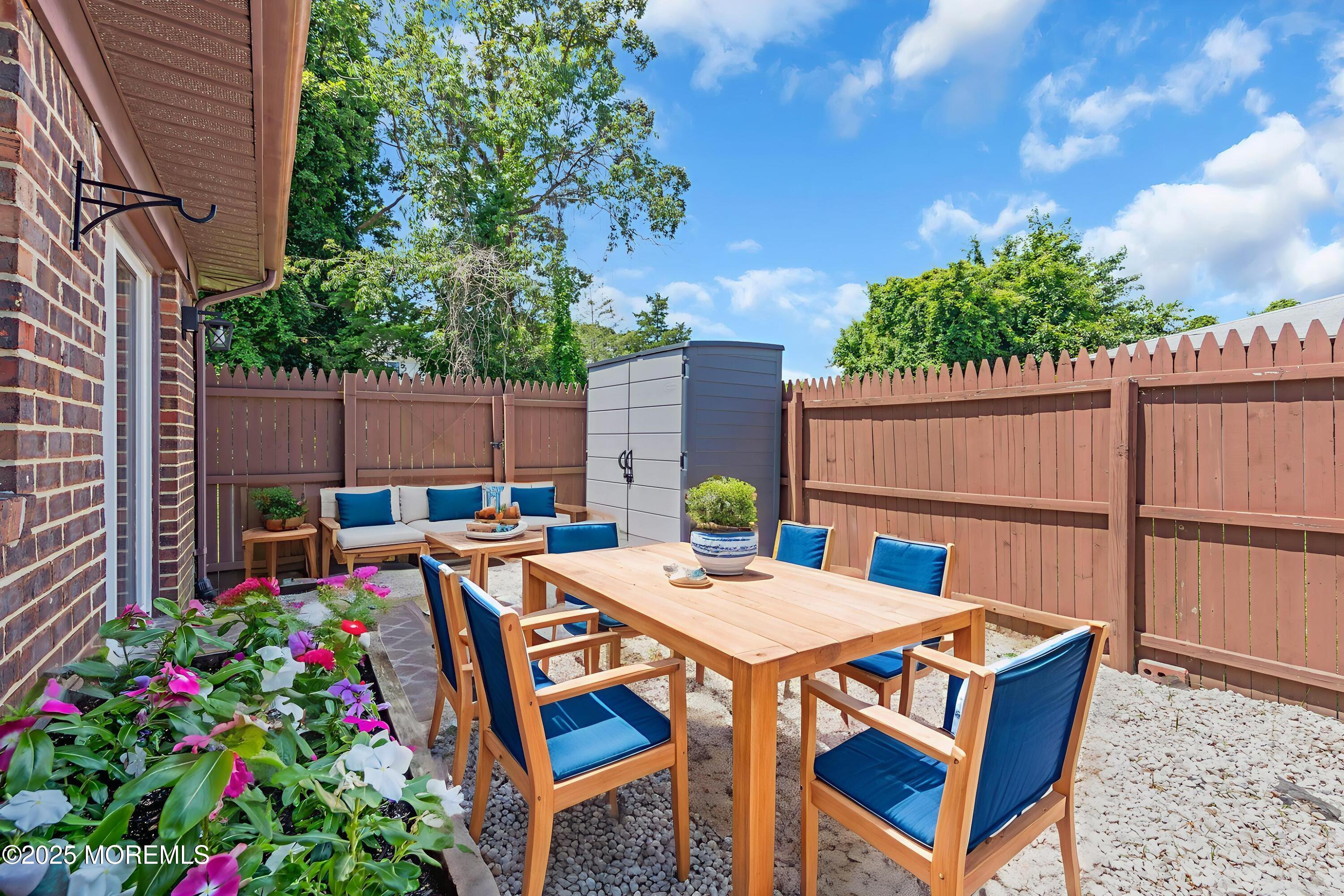 94 Greenwood Loop Road Brick, NJ 08724 - Photo 17 of 22 a view of a dinning table and chairs in the patio
