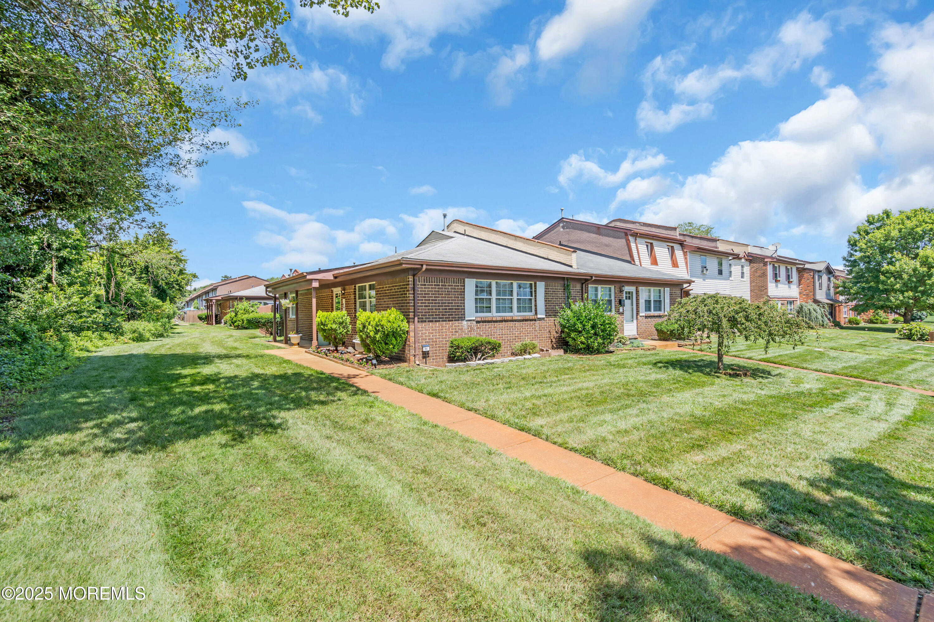 94 Greenwood Loop Road Brick, NJ 08724 - Photo 20 of 22 a front view of a house with a yard