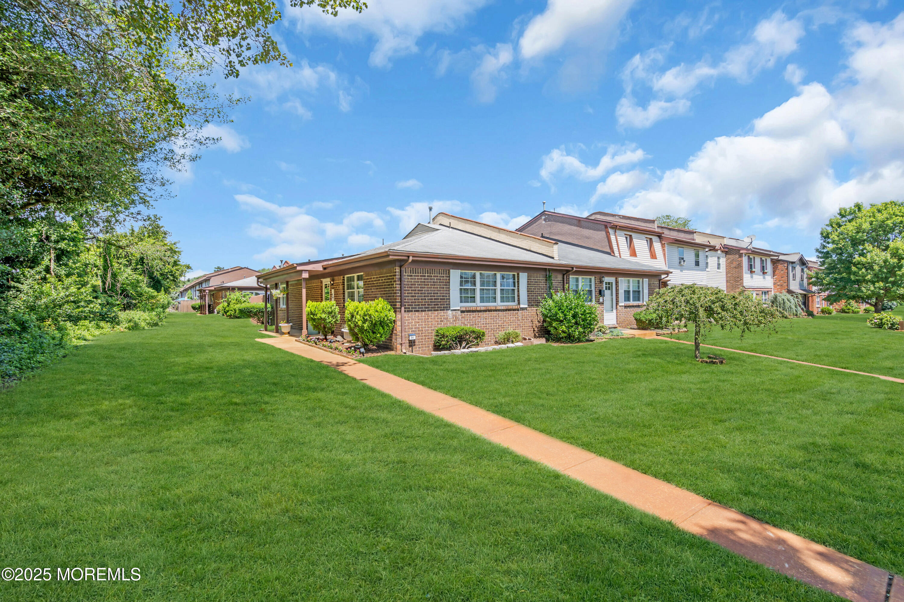 94 Greenwood Loop Road Brick, NJ 08724 - Photo 2 of 22 a front view of a house with a yard