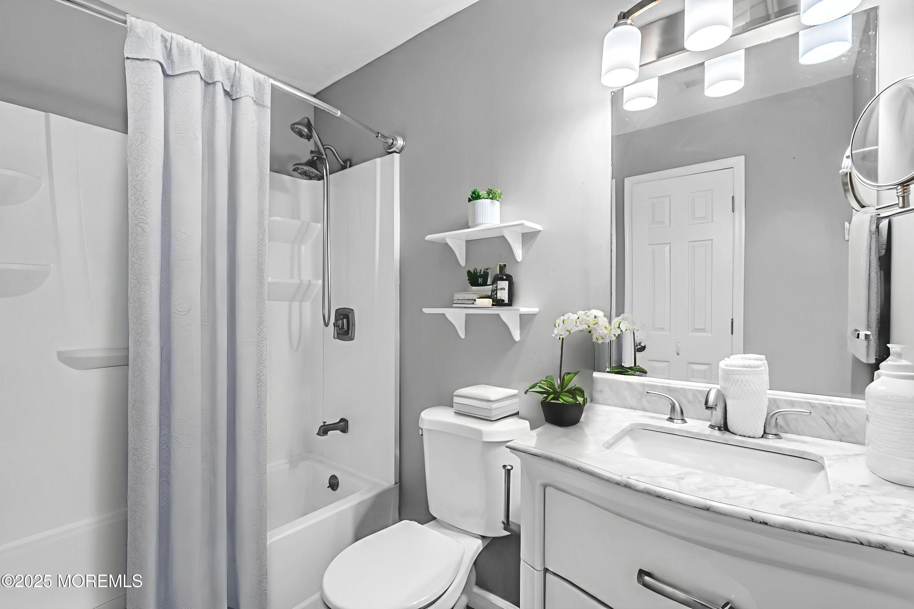 94 Greenwood Loop Road Brick, NJ 08724 - Photo 7 of 22 a bathroom with a granite countertop sink a toilet and shower