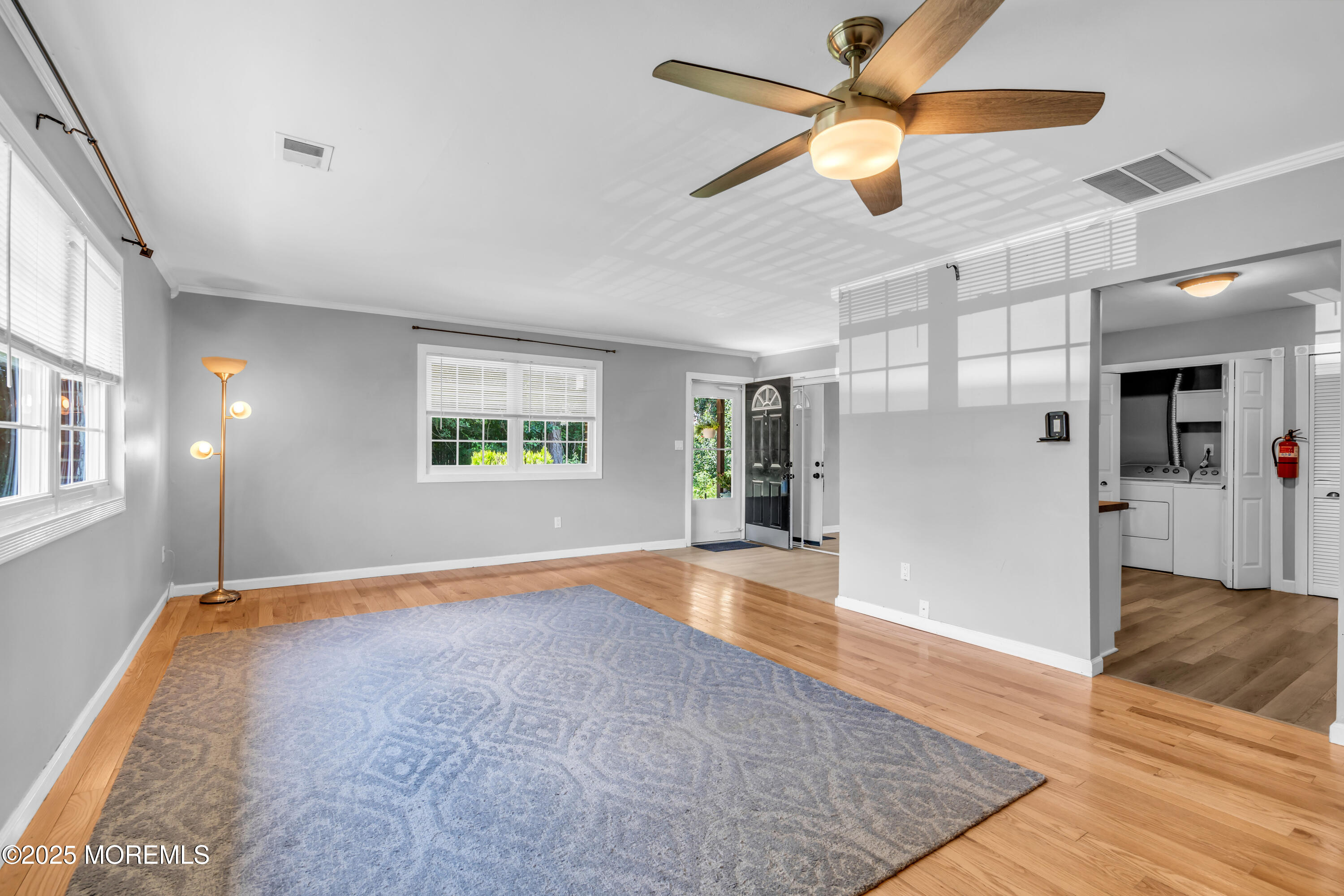94 Greenwood Loop Road Brick, NJ 08724 - Photo 9 of 22 a view of a livingroom with a ceiling fan and wooden floor