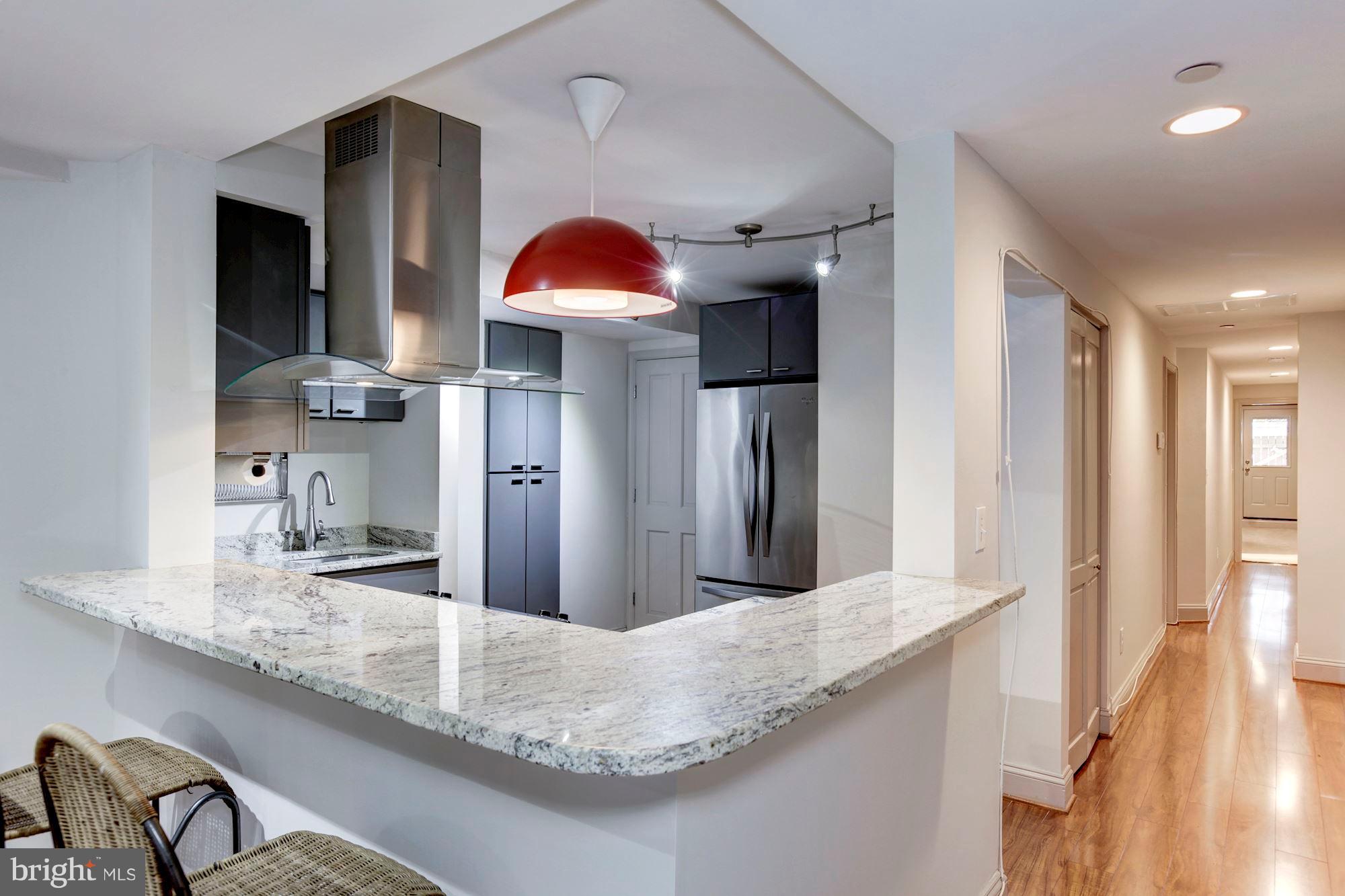 a kitchen with granite countertop a sink and stainless steel appliances