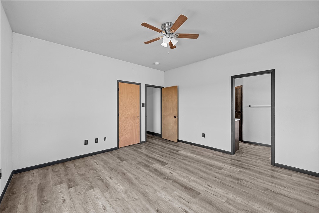 778 Rivercrest Road Valley Mills, TX 76689 - Photo 19 of 66 an empty room with wooden floor and ceiling fan