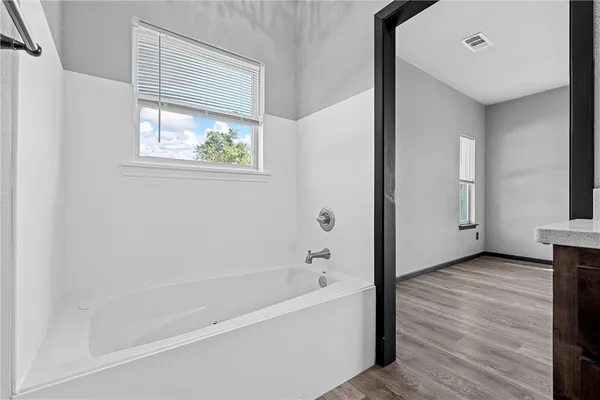 a view of an empty room with a ceiling fan