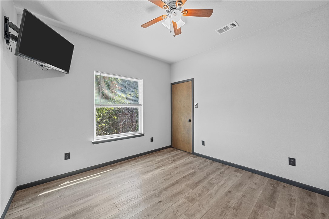 778 Rivercrest Road Valley Mills, TX 76689 - Photo 25 of 66 a view of an empty room with a window and a flat screen tv