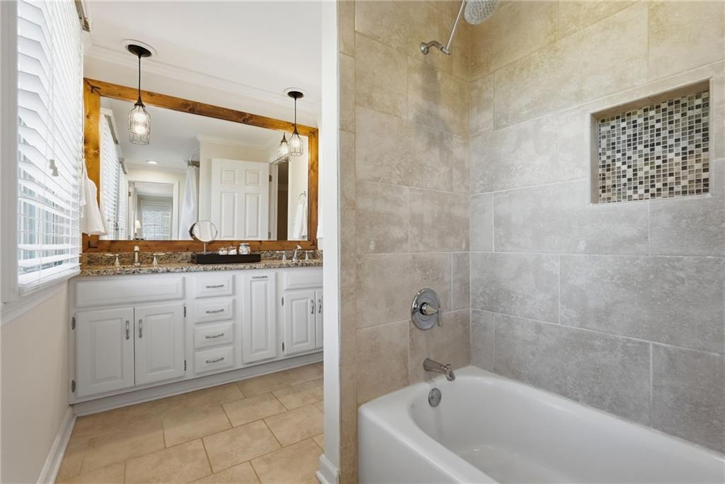 900 Settlers Ridge Road Pittsburgh, PA 15238 - Photo 30 of 50 Thoughtfully updated and serving Bedrooms #2 and #3, this well-appointed bath features a comfort-height dual-sink vanity with granite countertop, abundant storage, updated pendant lighting, and a soaking tub/shower combination.