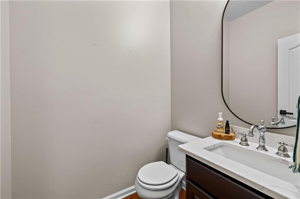 100 Portico Place Newnan, GA 30265 - Photo 11 of 51 a bathroom with a granite countertop sink vanity mirror and toilet