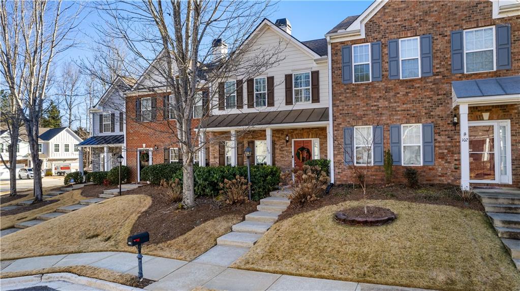 100 Portico Place Newnan, GA 30265 - Photo 2 of 51 a view of a brick building with many windows