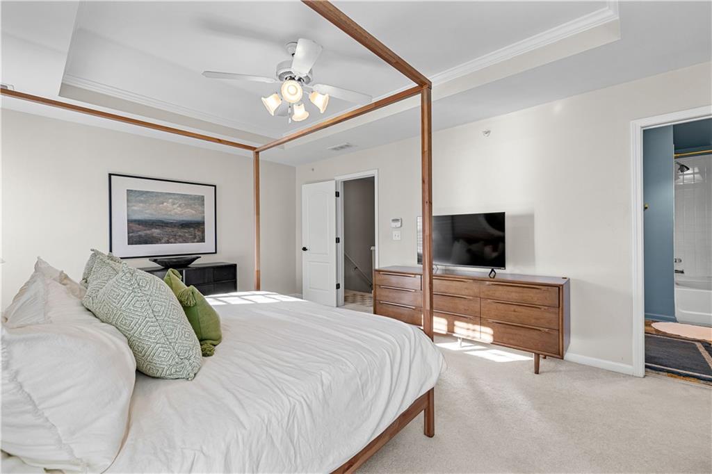 100 Portico Place Newnan, GA 30265 - Photo 21 of 51 a bedroom with a bed and a flat screen tv