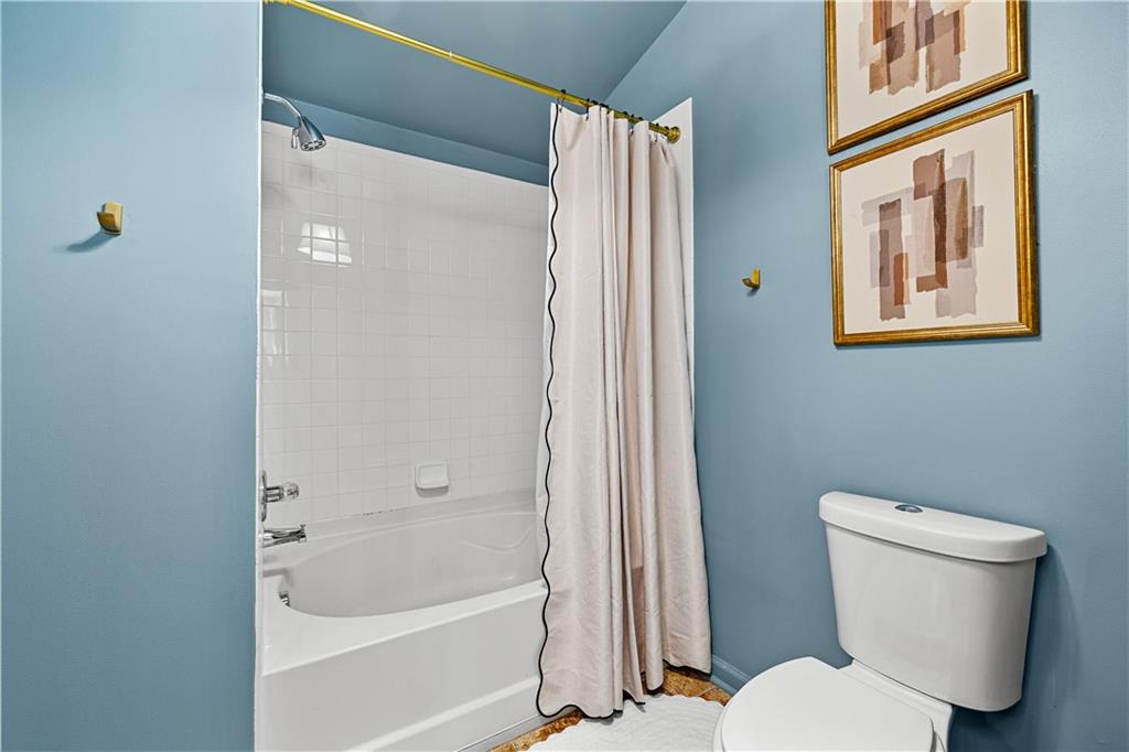 100 Portico Place Newnan, GA 30265 - Photo 24 of 51 a white toilet sitting next to a bath tub