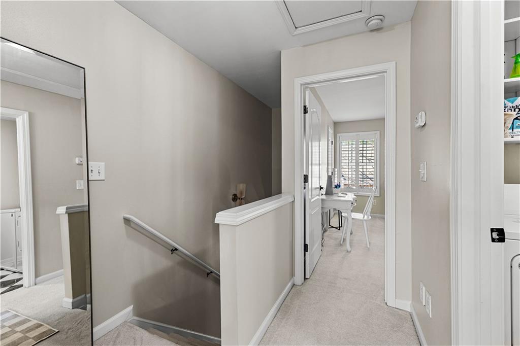 100 Portico Place Newnan, GA 30265 - Photo 25 of 51 a view of a hallway with a dining table and chairs