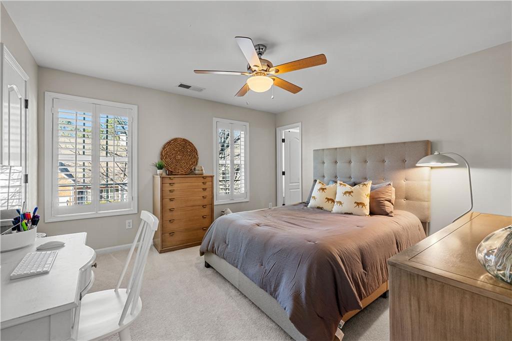 100 Portico Place Newnan, GA 30265 - Photo 27 of 51 a bedroom with a bed and a chandelier