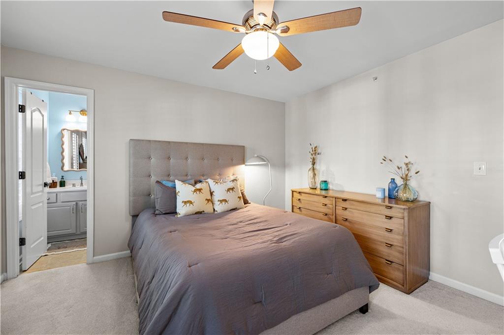 100 Portico Place Newnan, GA 30265 - Photo 28 of 51 a bedroom with a bed and a chandelier