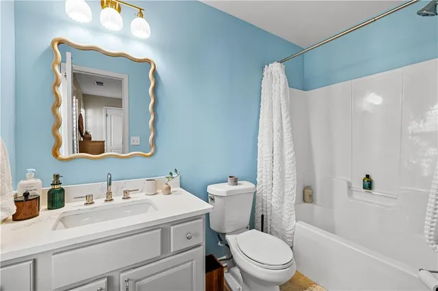 a bathroom with a toilet a sink and a mirror