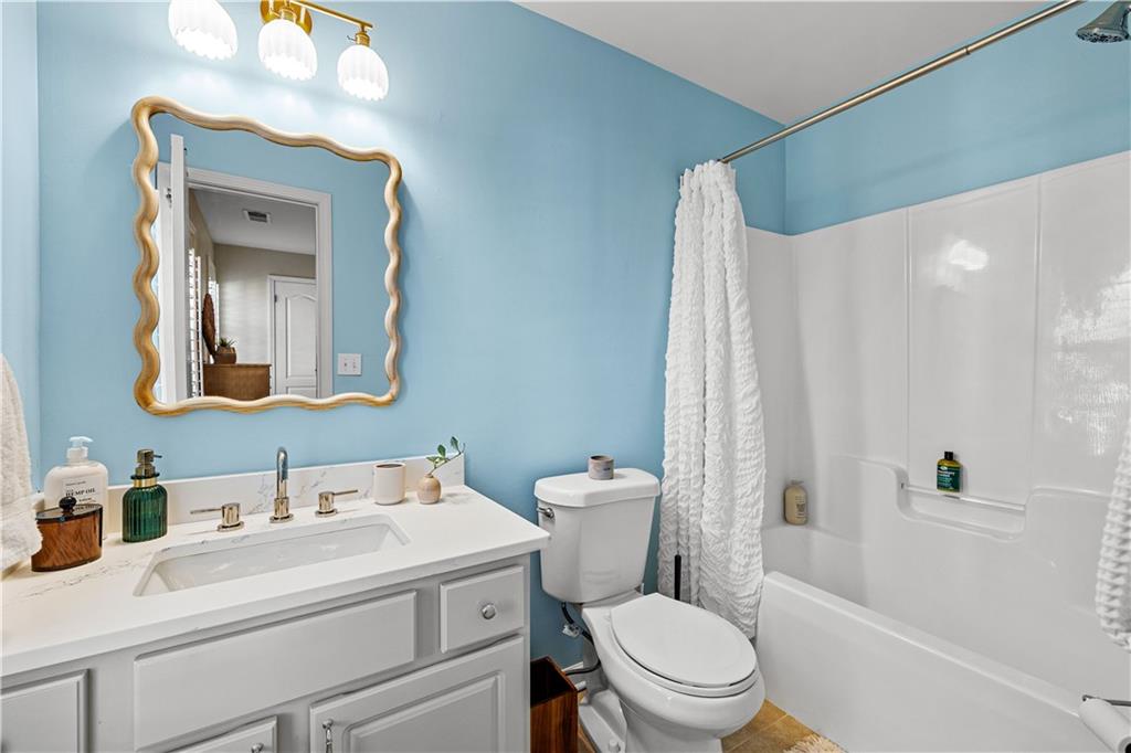 100 Portico Place Newnan, GA 30265 - Photo 29 of 51 a bathroom with a toilet a sink and a mirror