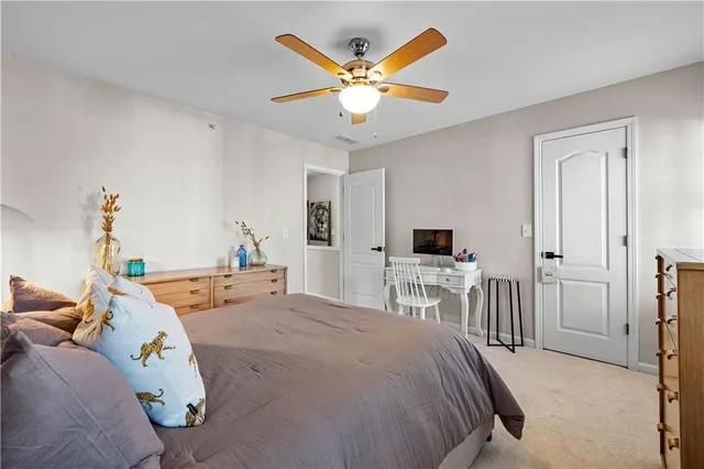 a bedroom with a bed and a ceiling fan