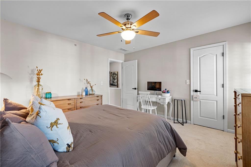 100 Portico Place Newnan, GA 30265 - Photo 30 of 51 a bedroom with a bed and a ceiling fan