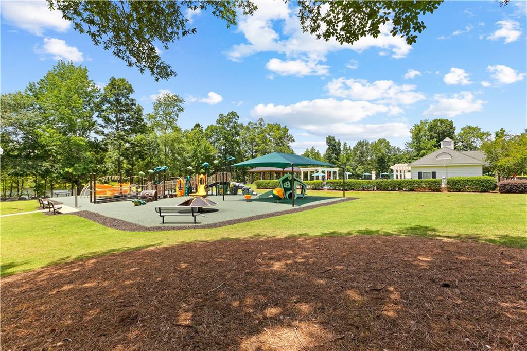 100 Portico Place Newnan, GA 30265 - Photo 46 of 51 a view of a swimming pool with an outdoor seating and a yard