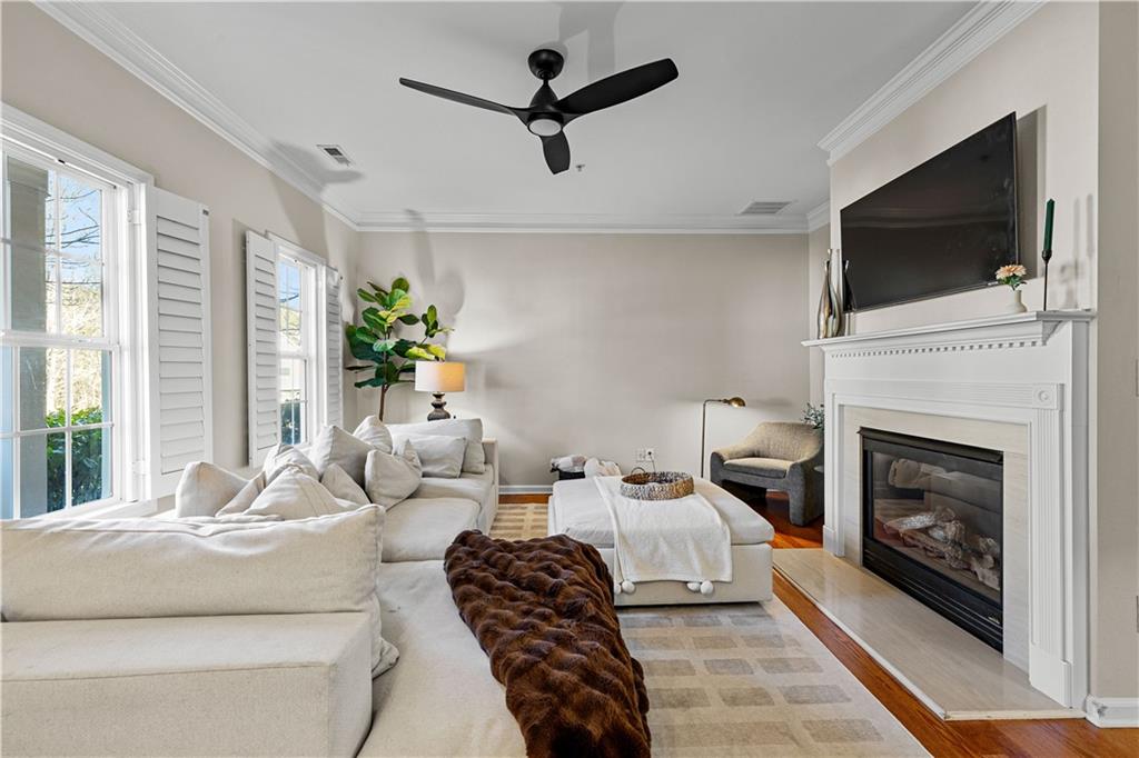 100 Portico Place Newnan, GA 30265 - Photo 8 of 51 a living room with furniture a flat screen tv and a fireplace