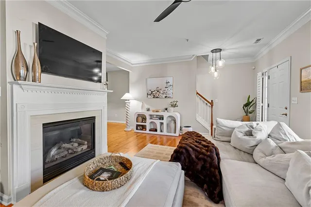 a living room with furniture a flat screen tv and a fireplace