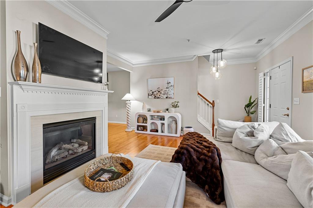 100 Portico Place Newnan, GA 30265 - Photo 9 of 51 a living room with furniture a flat screen tv and a fireplace