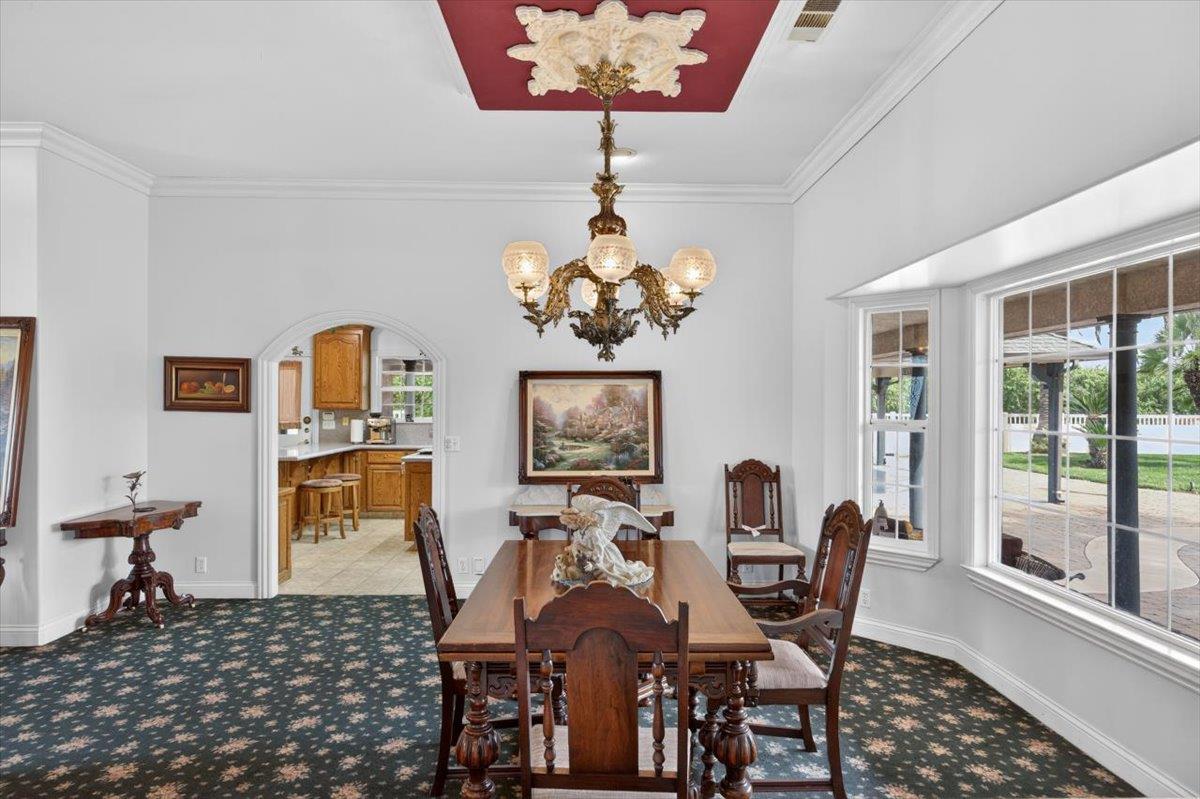 30324 Lone Tree Road Oakdale, CA 95361 - Photo 11 of 74 a view of a dining room with furniture and chandelier
